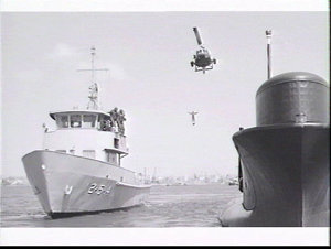 Diving tender TRV 254, an Iroquois helicopter and an RA...
