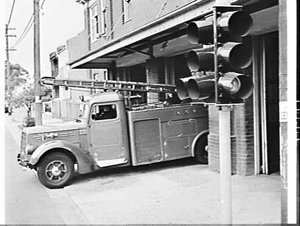 Firemen operate traffic lights from the fire station to...