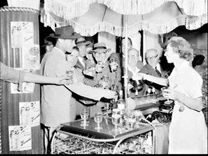 Barmaid serves drinks from a Mobilbars "Barmobile" at a...