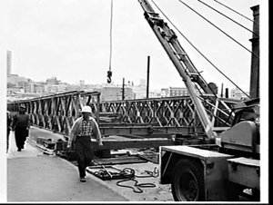 Workmen building a bailey bridge on the Pier Street Bri...
