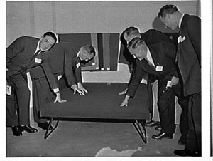 Businessmen at a party to launch the new Artwood sofabe...
