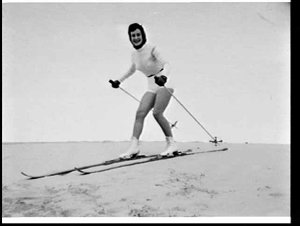 Fashion model Beverly Evans skiing on sand, Rosebery