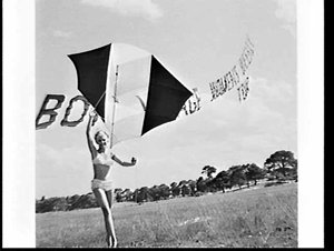 Fashion model in two-piece swimsuit with a kite and str...