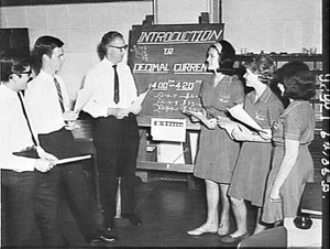 Rural Bank staff studying an introduction to decimal cu...