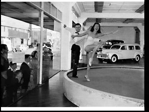 Dancers Ray McDonald and Peggy Ryan dance on a car disp...