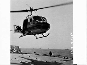 Iroquois helicopter over the deck of HMS Devonshire, fl...
