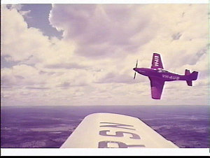 Aviator Aubrey Oates flying his red Mustang fighter VH-...