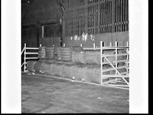 Wool bales in a pen on the wharf to be loaded onto the ...