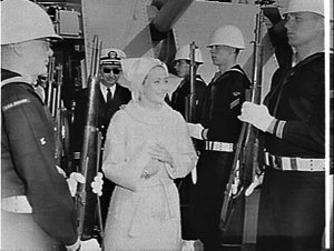 Film star Jane Powell inspects a guard of honour on boa...