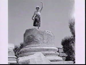 Norma Fleming poses as a statue on a Roman column in th...