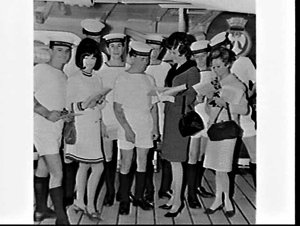 Rural Bank women staff hand out wallets on HMS Victorio...