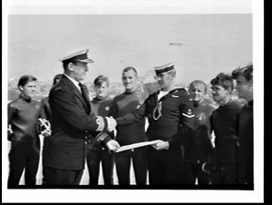 Leading Seaman J. Garrett receives citation from Admira...