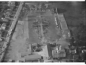 Aerial photographs of Holy Cross College with people making the shape of a large cross on the playing field, Ryde