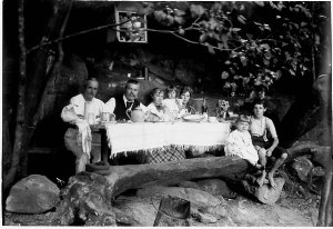 Perier family in kitchen of camp in rock shelter, Middl...