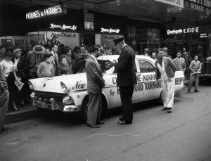 Mr. Chittick driving the Hollywood Tournament of Thrills Ford Customline being given a traffic ticket by police