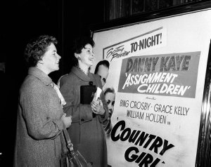 Two women view the foyer advertisement for Country girl...