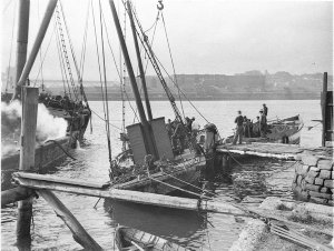 Raising a sunken power barge from harbour bed