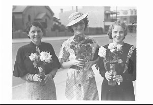 Three women display their prize winning roses