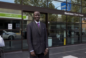 Item 04: Lawyer Deng Adut poses for a portrait in front...