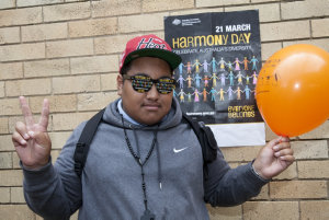 Item 014: A student poses for a photo with 'Harmony Day...