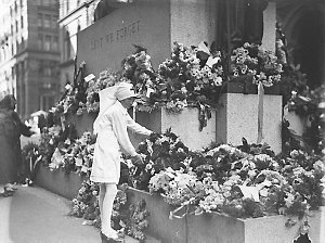 A Junior Red Cross girl lays a wreath on the Cenotaph