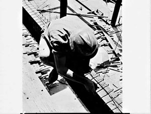 Photographs of builders labourers working on a building...