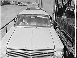 Unloading new Ford Falcon cars and station wagons, Cook...