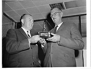 Presentation of a transistor radio and trophy to the IC...