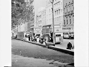 Sydney streets and pedestrians with Government buses wi...