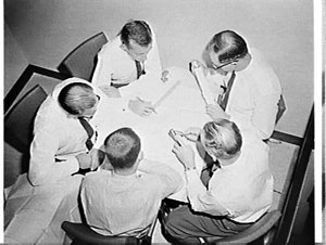 Birds-eye photograph of CIG engineers discussing plans