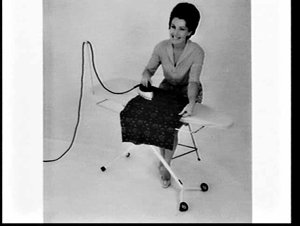 APA studio photograph of woman sitting down and ironing...