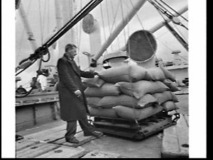 Loading sacks of rice onto the cargo ship Doros, Melbou...