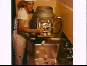 Sailor using Peelmaster potato peeler in the kitchens a...