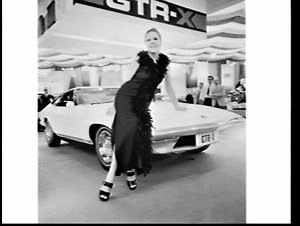 Fashion model poses with Holden car at the Motor Show, ...