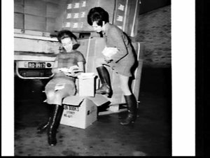 Fashion models reading Sun Books in promotional photogr...