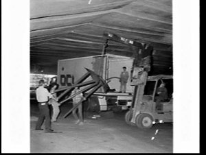 Builder's labourers unload an Overseas Containers (OCL)...