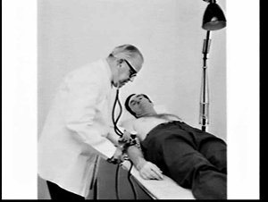Doctor examines bussinessman at M.M.I. clinic