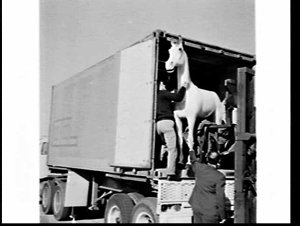Unloading a life-size model of the White Horse Whisky l...