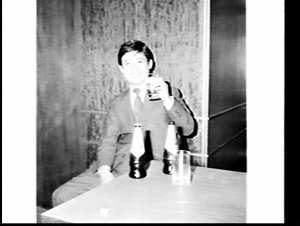 Publicity photograph of Japanese man drinking Reschs La...