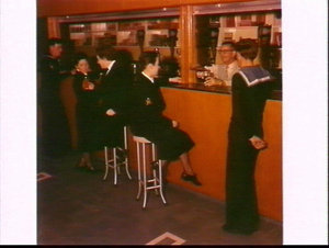 Sailors enjoy a drink in the bar at HMAS Watson