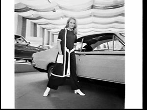 Fashion model poses with Holden car at the Motor Show, ...
