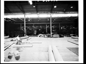 Pre-cutting wall-to-wall carpet at Waltons' warehouse, ...