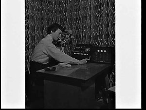 Telephonist with telephone switchboard and IBM Paging S...