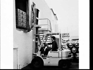 Mitsubishi fork-lift moving cartons of beer, Coogee Bay...
