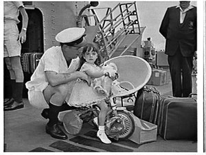 Naval officer and his daughter on the deck of HMAS Quib...