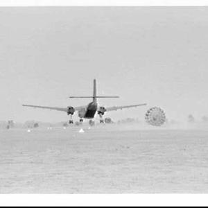 Army test air drop of equipment from a Caribou aeroplan...