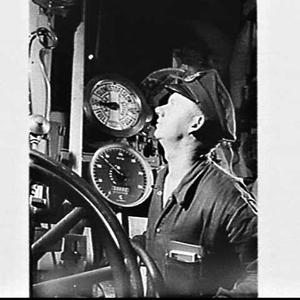 Engineer checking gauges in the engine room of HMAS Anz...