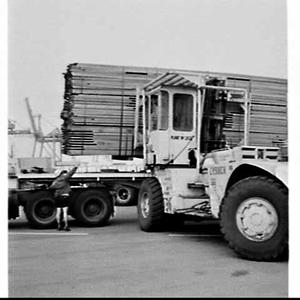 Unloading timber from a semi-trailer using a fork-lift ...