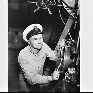 Petty officer setting valves in the engine room of HMAS...