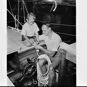 Len Staples and his son tying knots on his yacht Solque...